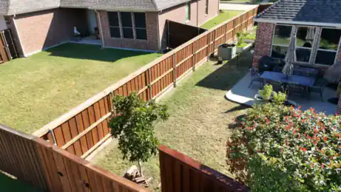 Aerial view of cedar fencing around a landscaped backyard.