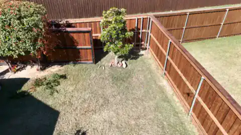 Aerial view of cedar fencing around a landscaped backyard.