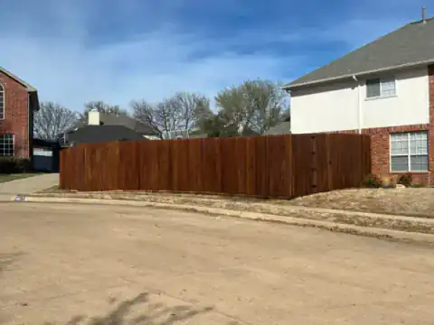 Cedar privacy fence follows a curved neighborhood street.