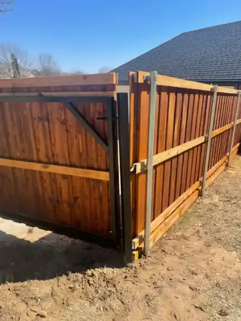 Cedar privacy fence turns a finished corner around a yard.