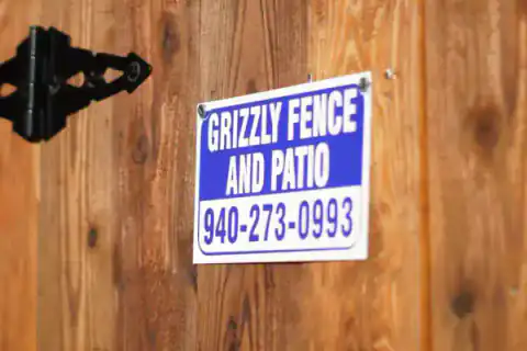 Grizzly Fence and Patio sign mounted on a cedar gate.