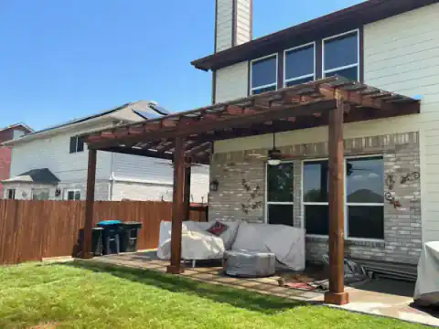 Cedar pergola frame takes shape beside a North Texas home.