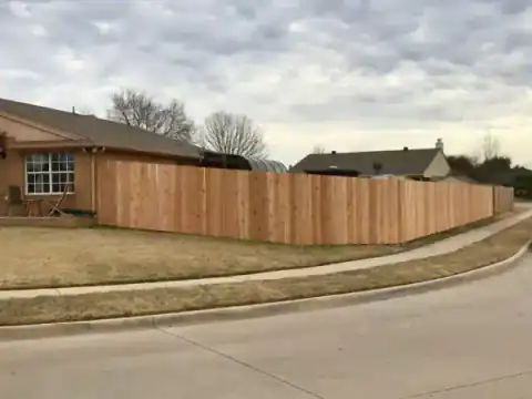 Cedar privacy fence follows a residential street.