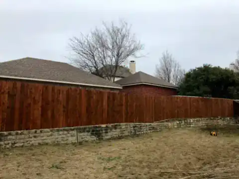 Cedar privacy fence borders a residential street.