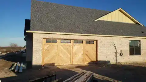 Covered patio framing takes shape behind a North Texas home.