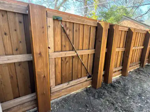 Cedar double gate closes a narrow residential side yard.